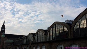 Looked up and spotted a hot air balloon over the city of Hamburg Germany